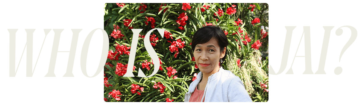 Jai, Thai chef surrounded by red flowers
